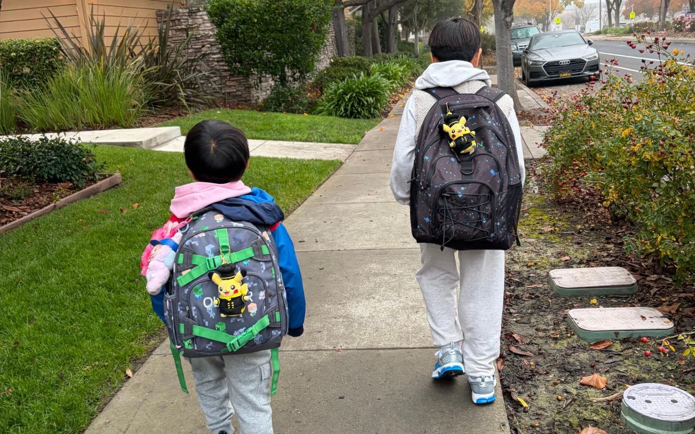Two youngsters walking away from the camera